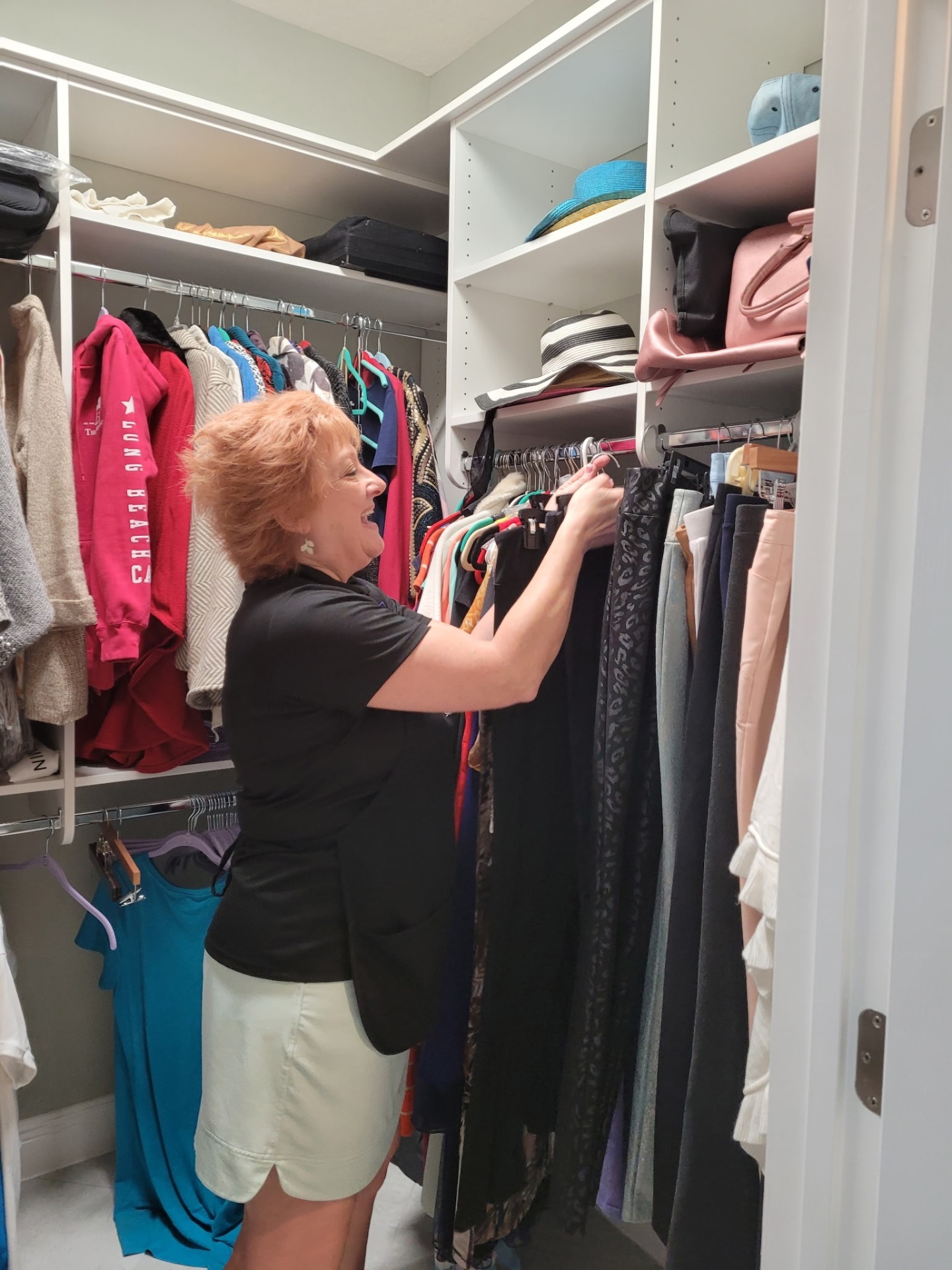 Tina organizing a client's closet after their move